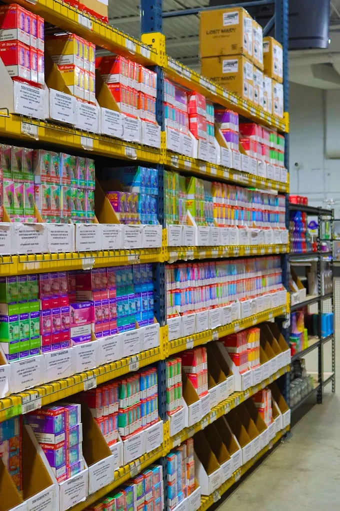 Vape wholesale warehouse shelves stocked with disposable vape displays from Geek Bar Foger Rinnbar and other brands